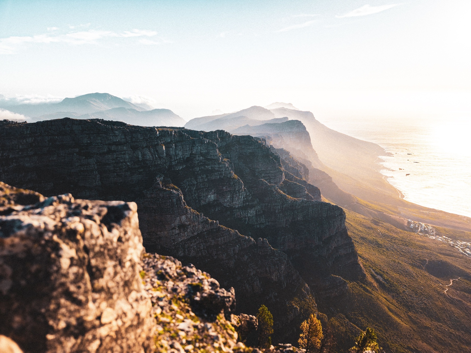 Table Mountain cliffs at golden hour above the Cape Town coastline